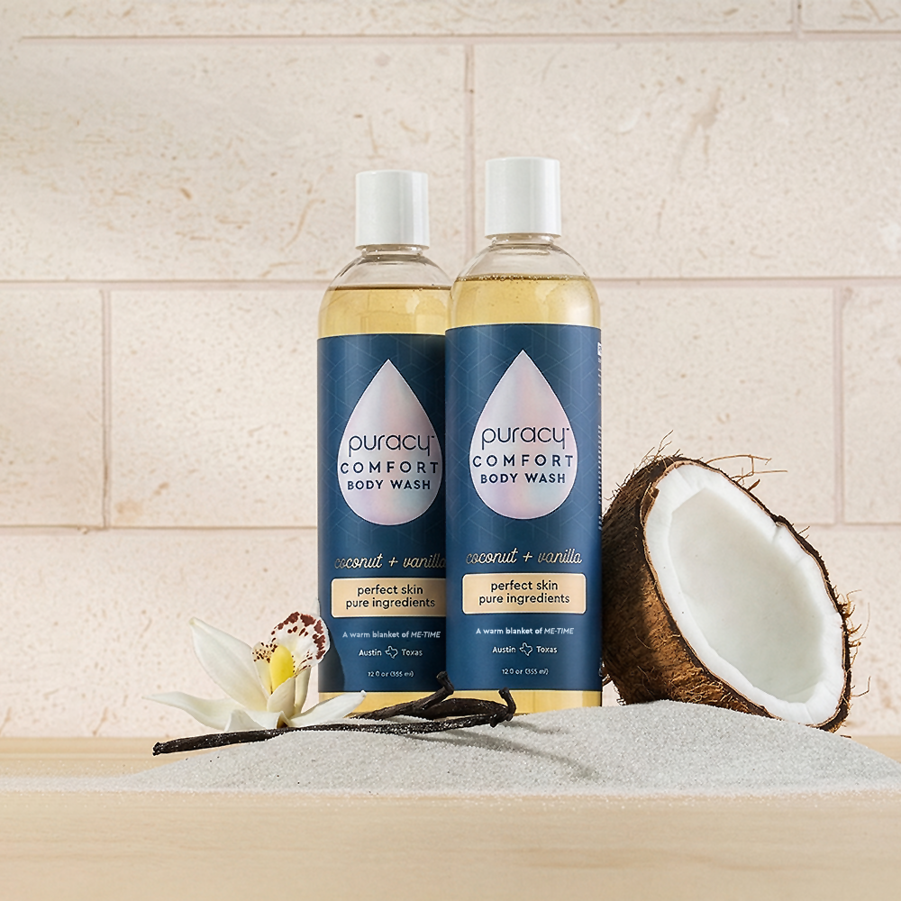 Two bottles of Puracy Body Wash (Acidified, PH Balanced) with coconut and vanilla on a light background.