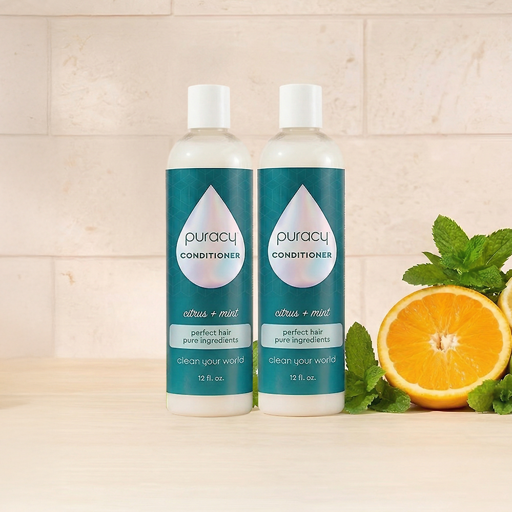 Two bottles of Puracy Conditioner (Silicone/Dimethicone/Sulfate Free), near mint and orange.