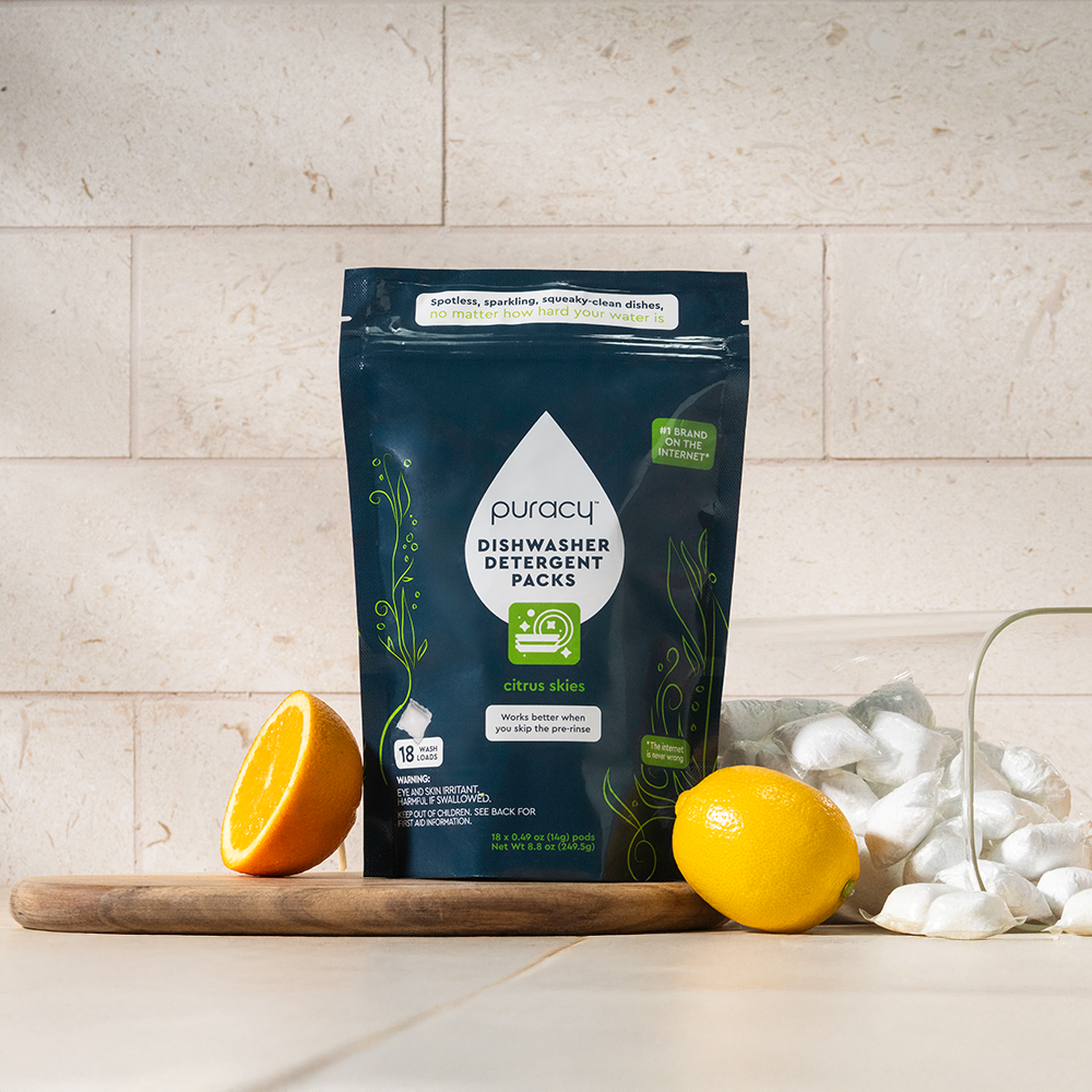 A bag of Dishwasher Detergent Pods with a plant-derived formula sits on a kitchen counter.