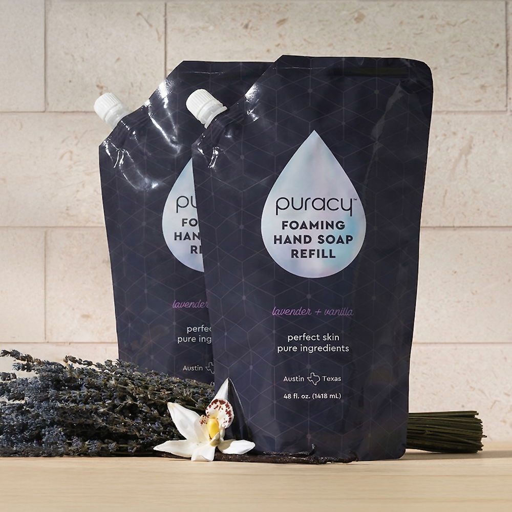 Two Foaming Hand Soap refill pouches beside dried lavender and a white flower.