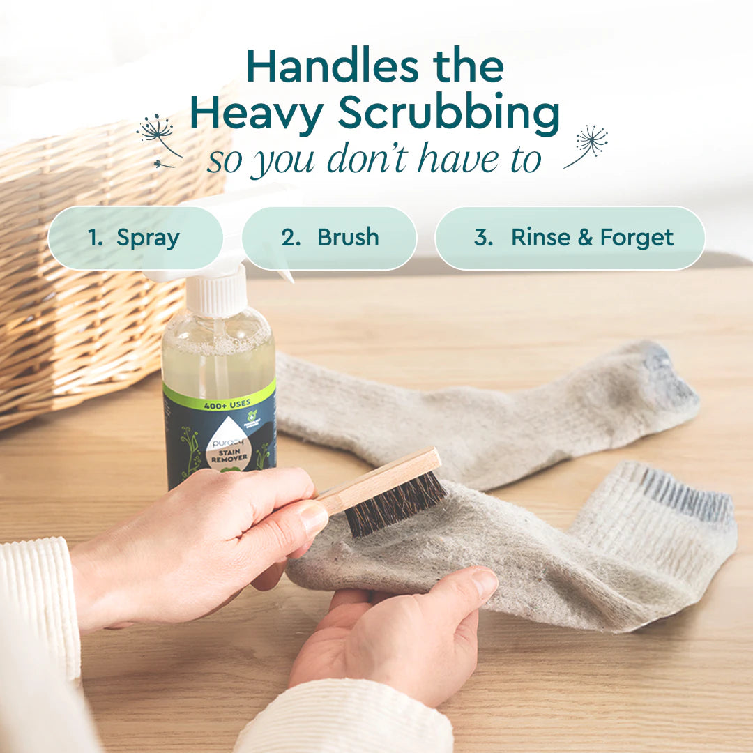 A hand scrubs a dirty sock with the Laundry Stain Remover Brush; Puracy bottle visible nearby.