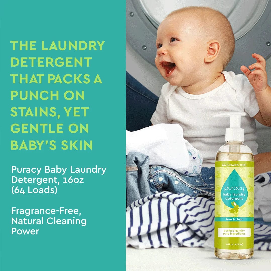 A smiling baby sits in a laundry room next to a bottle of Baby Laundry Detergent containing plant-based enzymes, surrounded by clothes.