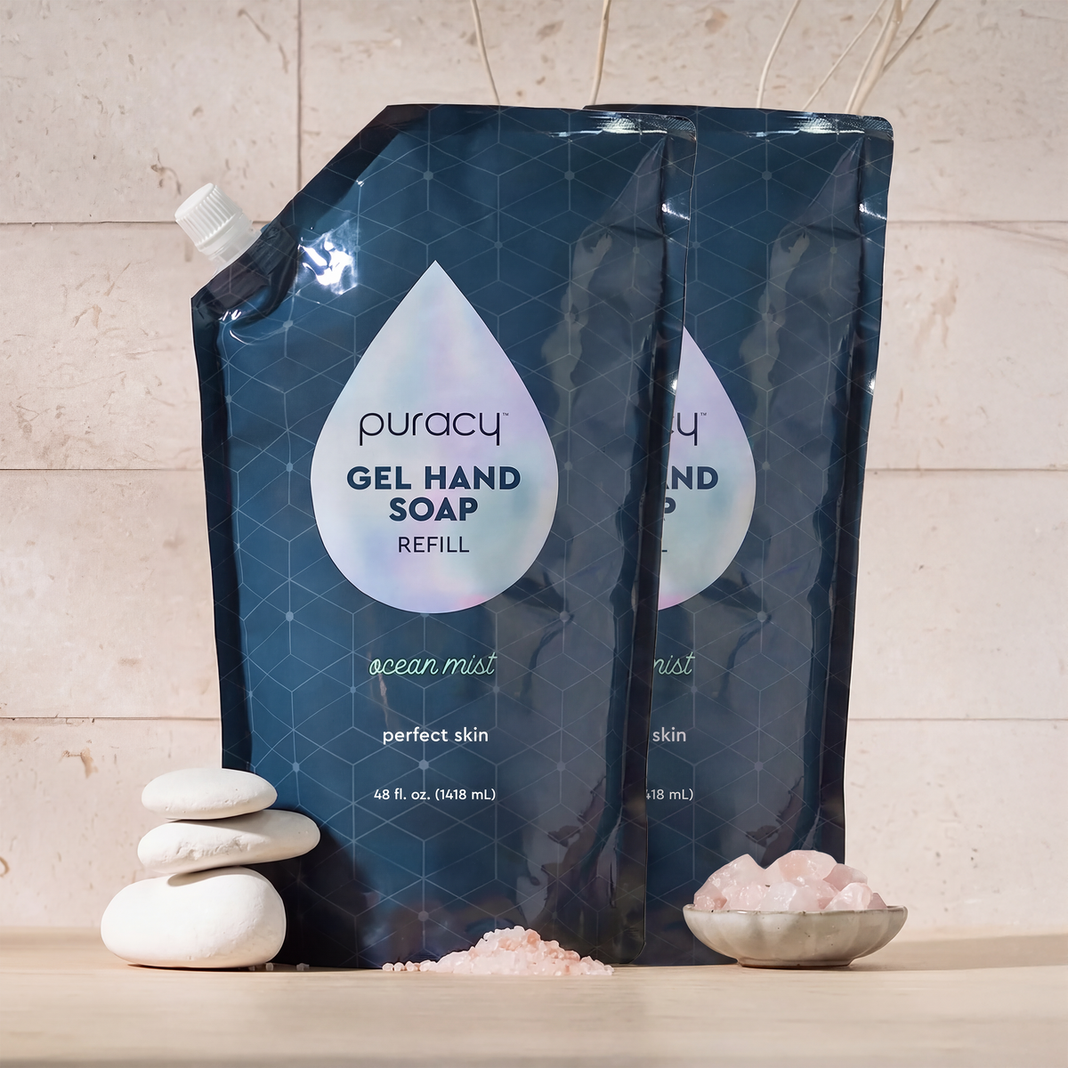 Two pouches of Gel Hand Soap with white stones and pink bath salts arranged nearby.