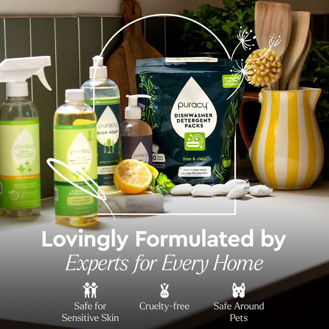 Everyday Multi-Surface Cleaner on a kitchen counter with lemons, plants, and a yellow-striped pitcher.