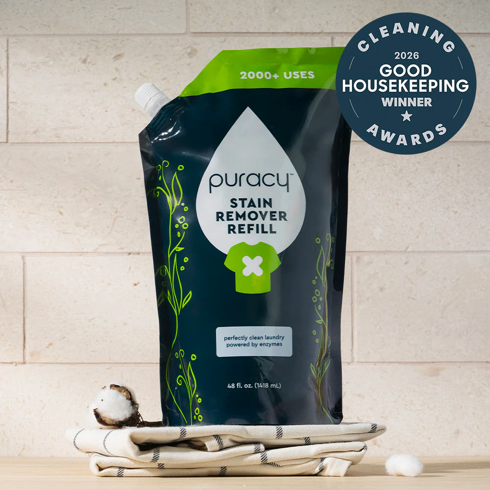 Laundry Stain Remover refill pouch on towels with a Good Housekeeping Award badge beside it.