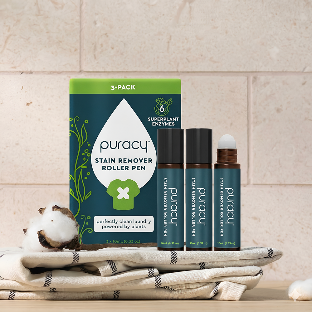 Stain Remover Roller Pen and box on folded towels, with cotton balls in front.