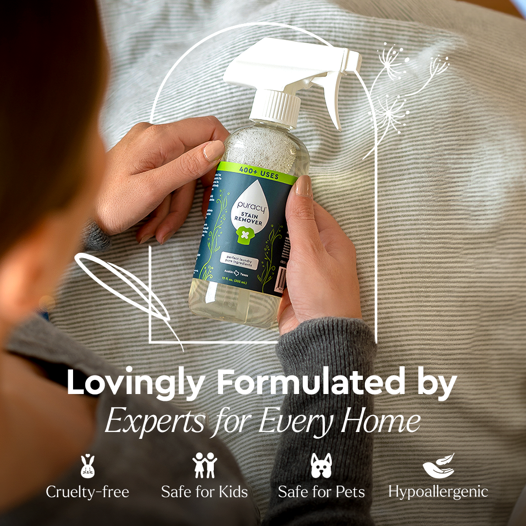 Person holding Laundry Stain Remover by Puracy on a bed, highlighting cruelty-free, hypoallergenic features.#common#scent_unscented