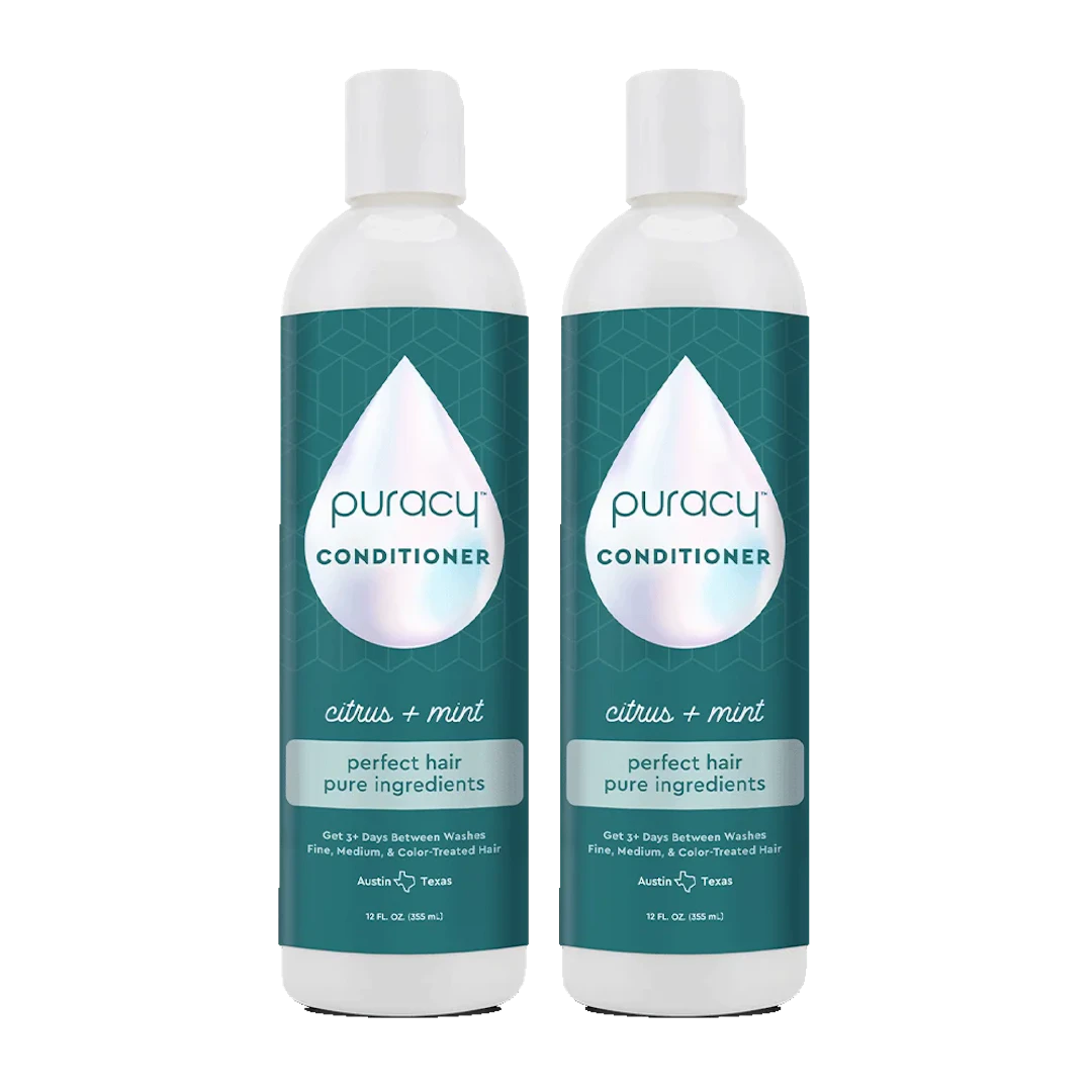 Two bottles of the Puracy Conditioner (Silicone/Dimethicone/Sulfate Free), infused with natural essential oils for deep hydration, are adorned with a teal label and white cap. This formula, free from sulfates, gently nourishes your hair.