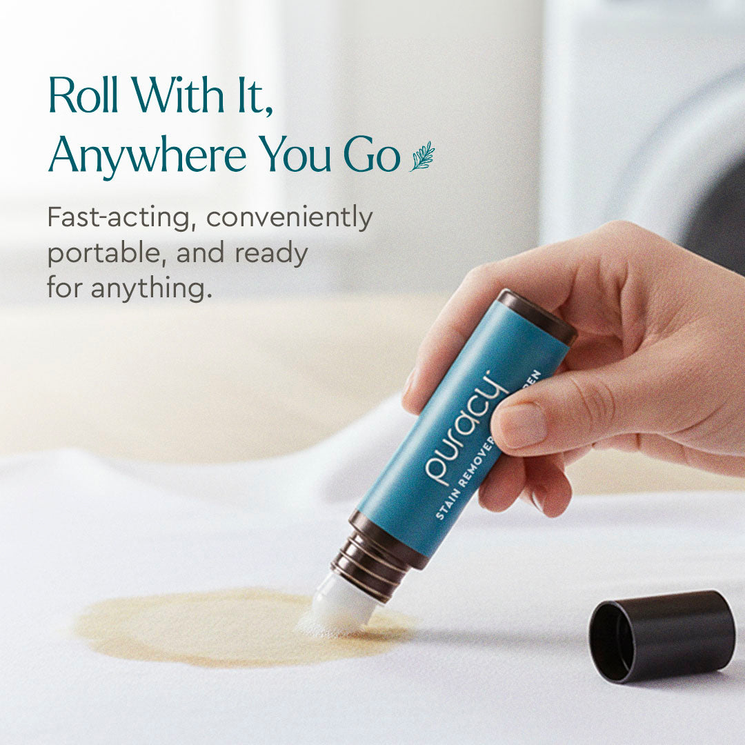 Hand using Laundry Stain Remover stick on stained fabric; cap off and visible beside the stick.