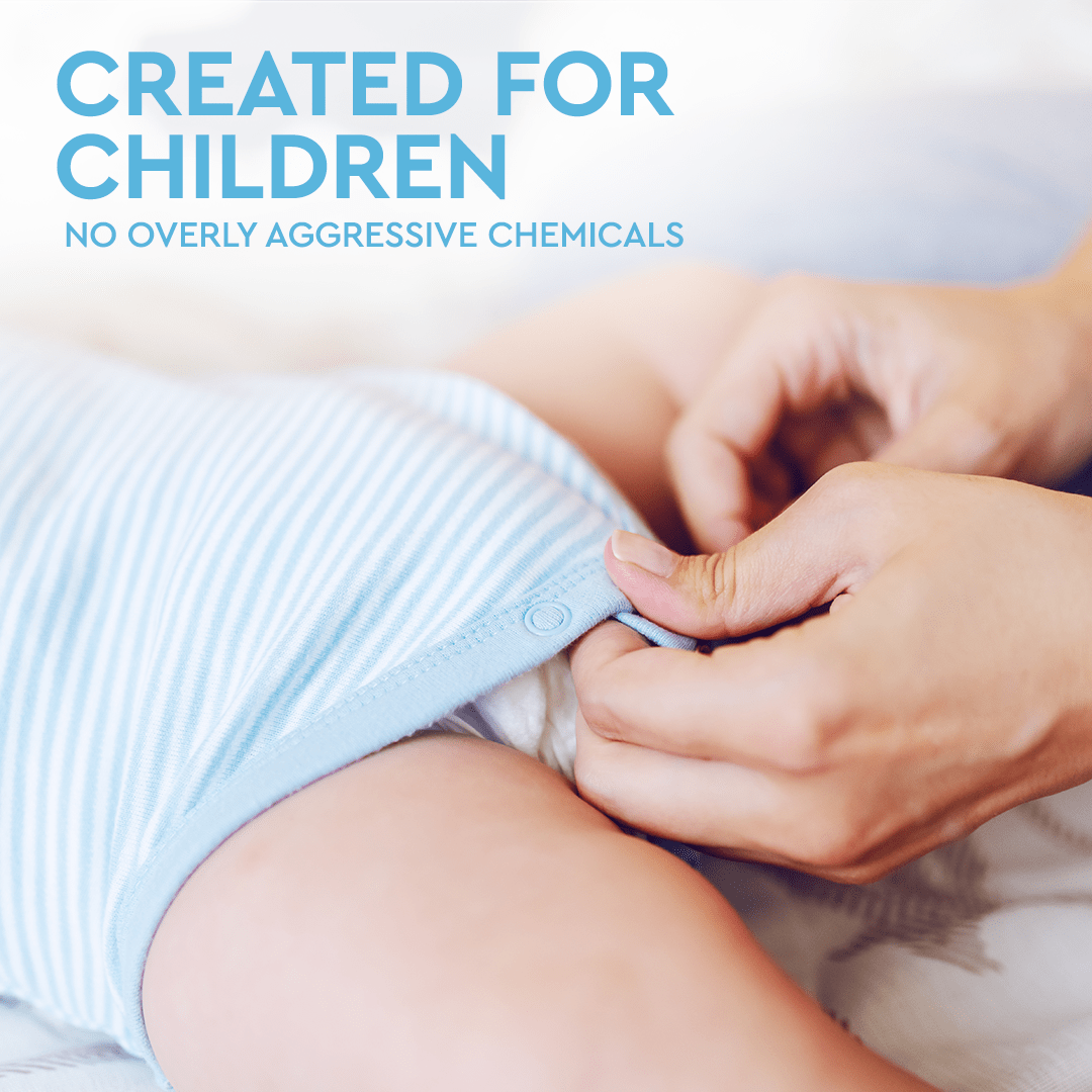 Person using Natural Baby Laundry Stain Remover to adjust baby's blue striped outfit, text reads Created for Children, Enzyme Odor Eliminator, Free & Clear of Overly Aggressive Chemicals.