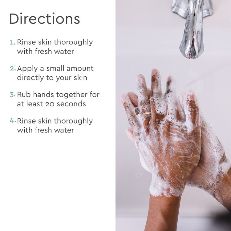 Washing hands with the Foaming Hand Soap under a faucet, which includes clear directions on the side for effective use. The soap is crafted from biodegradable, plant-based ingredients to ensure an eco-friendly clean.