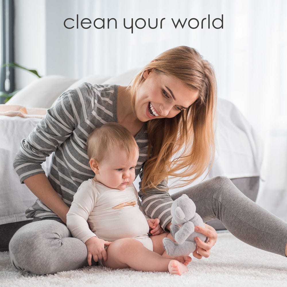 Smiling woman and baby play on floor; text reads “Naturally Clean your world with Instant Spot Remover.”.