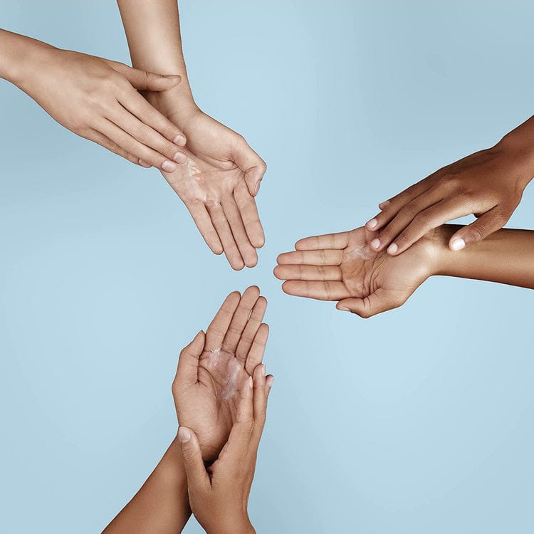 Five hands of diverse skin tones extend towards each other against a light blue background, symbolizing unity through shared care. Their gentle touch reflects the nourishing power of Gel Hand Soap, a cleansing liquid made with plant-derived ingredients to moisturize and hydrate.