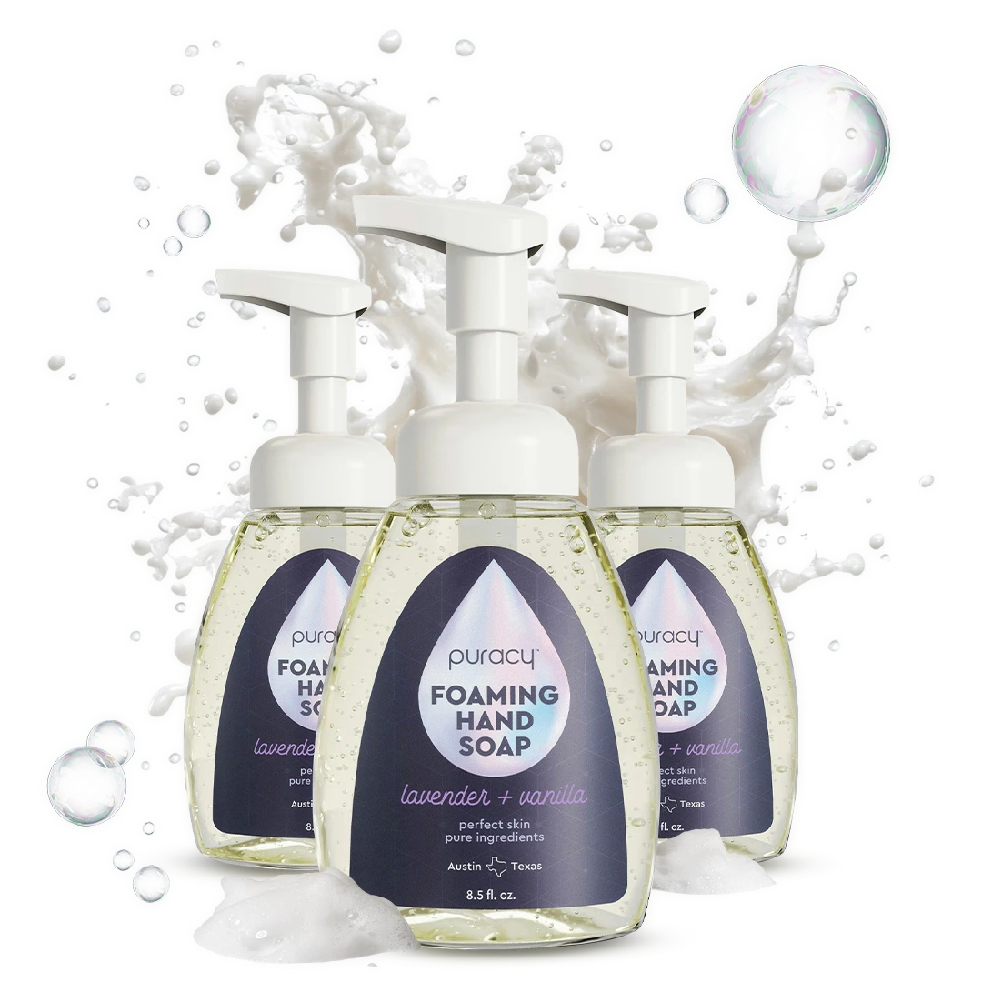 Three bottles of Foaming Hand Soap with plant-based ingredients and lavender, surrounded by soap bubbles.