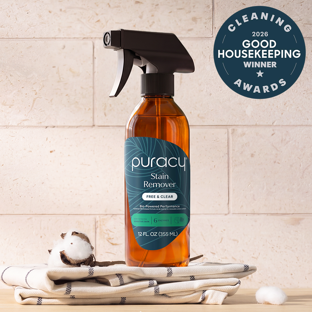Laundry Stain Remover spray bottle on towels with cotton ball, award badge in corner.