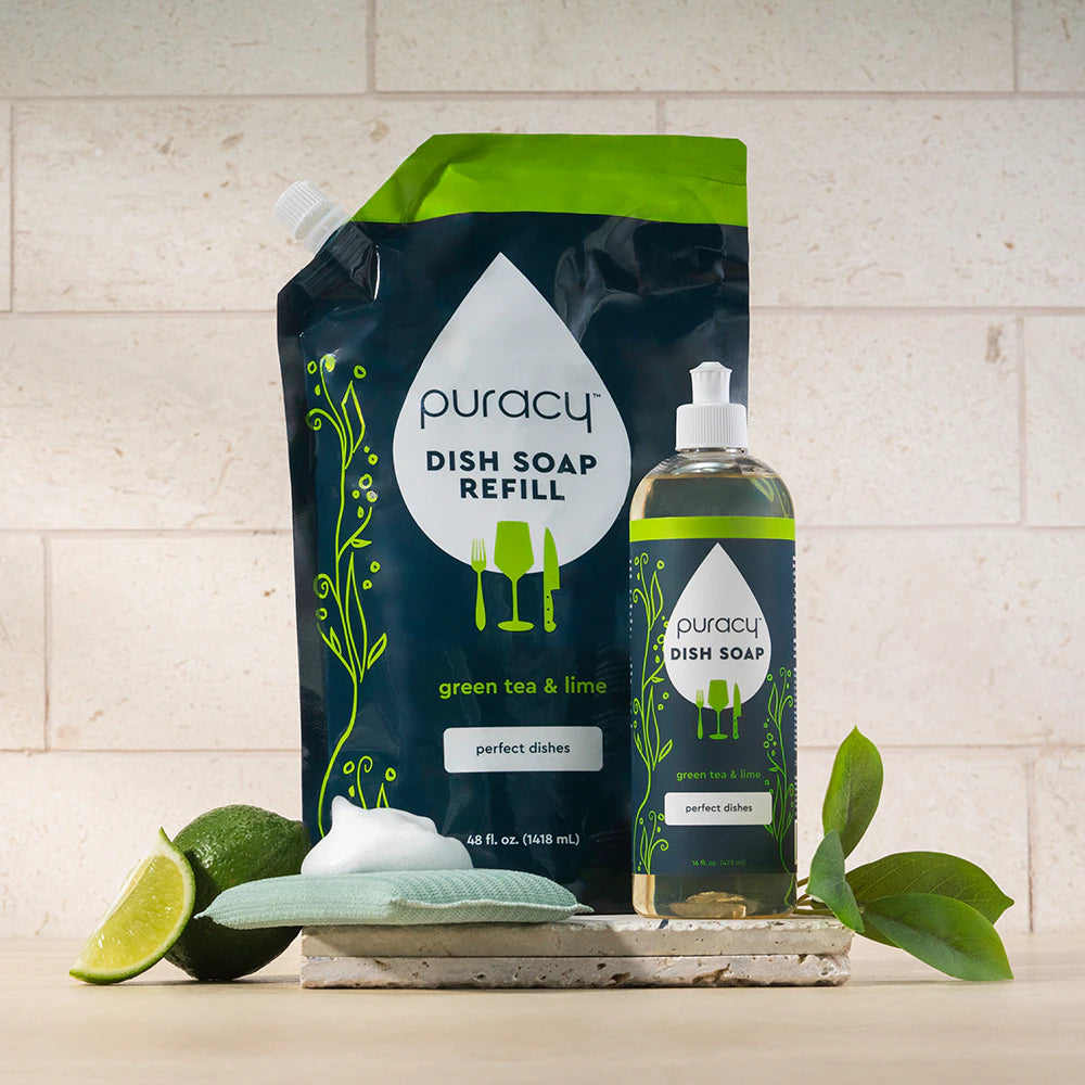 Puracy Dish Soap with green tea & lime, refill pouch and bottle, plus sponge on a countertop.