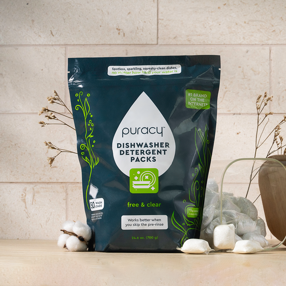 Dishwasher Detergent Pods on a counter with cotton and dried flowers.