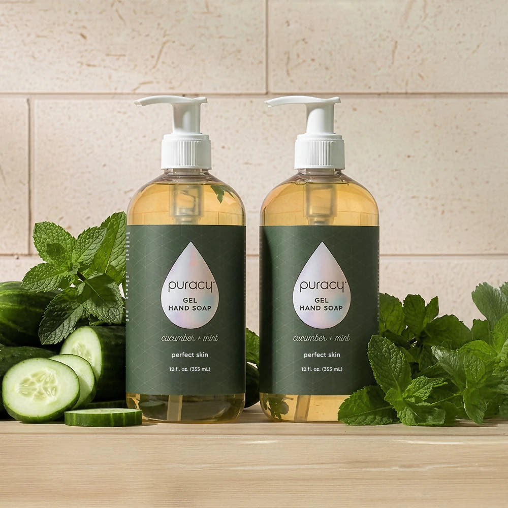 Two bottles of Gel Hand Soap with cucumbers and mint on a wooden surface.