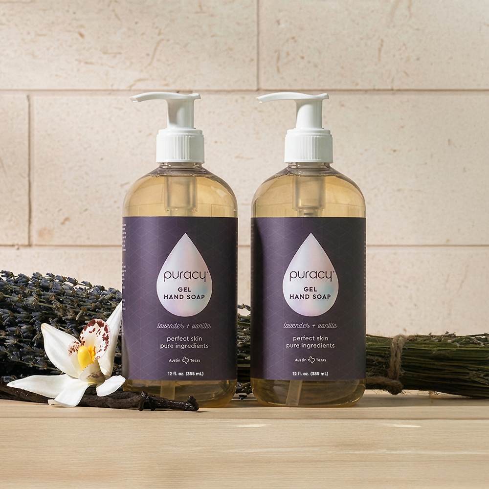 Two bottles of Gel Hand Soap, moisturizing with lavender and vanilla, pictured with sprigs behind.