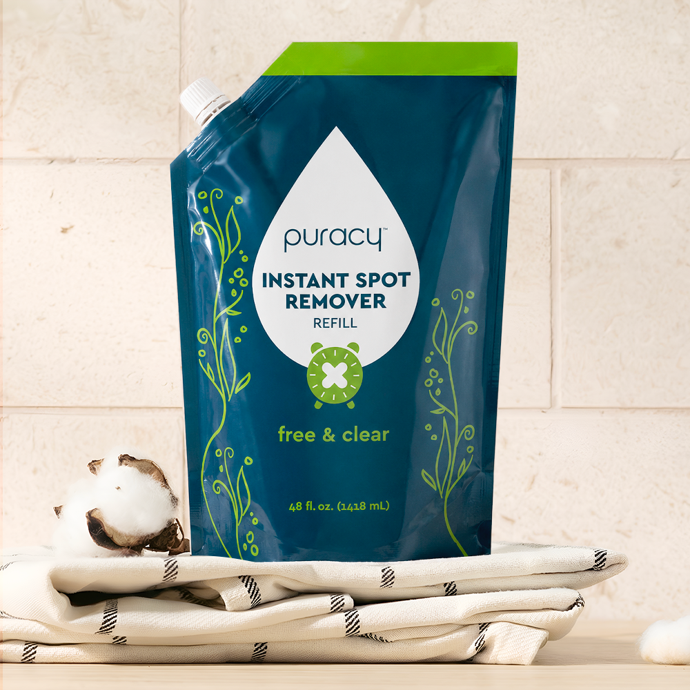 A pouch of Instant Spot Remover, a powerful odor eliminator, sits on folded towels.