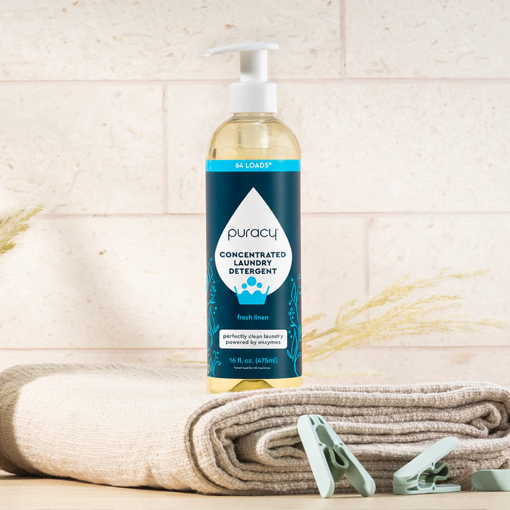 Sulfate-Free Laundry Detergent (Concentrated) bottle on folded towels, with clothespins and tiles.