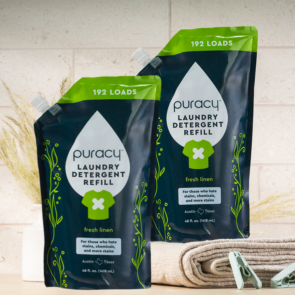 Two Laundry Detergent (Concentrated, Sulfate-Free) pouches for 192 loads sit by folded towels.