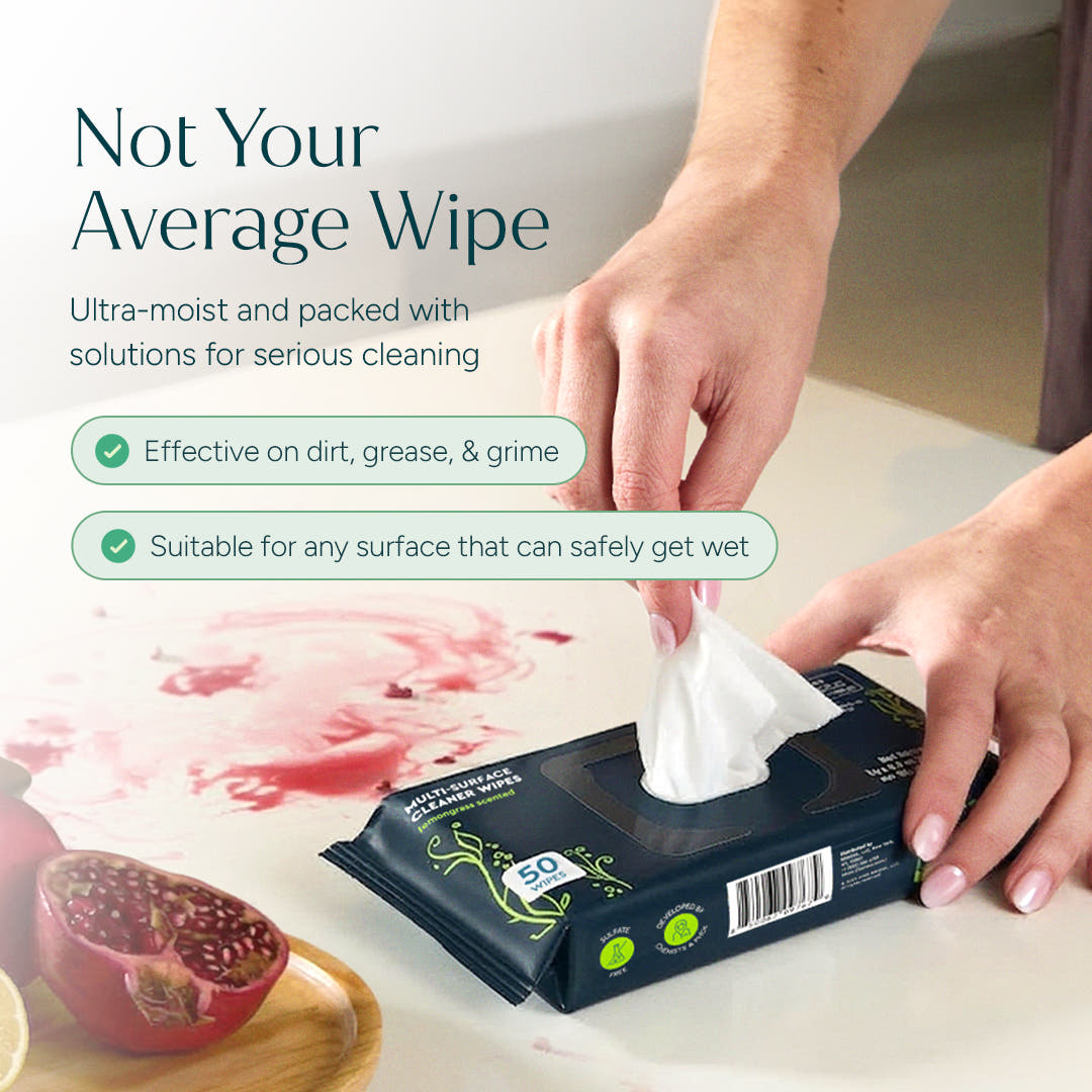 Using Multi-Surface Cleaner Wipes to clean a red spill near a cut pomegranate on the counter. #common