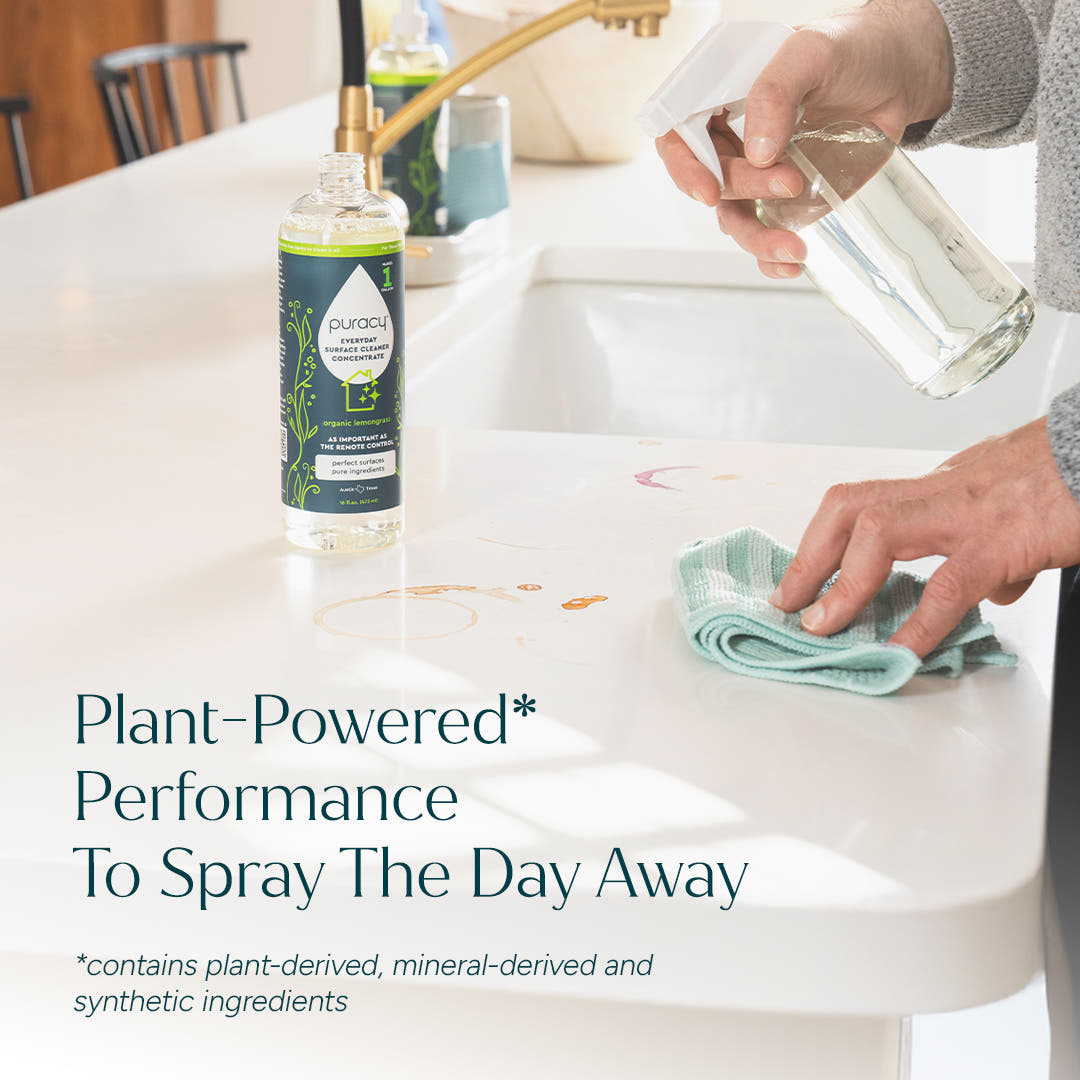 Someone cleans a kitchen counter with Everyday Multi-Surface Cleaner using a spray bottle.