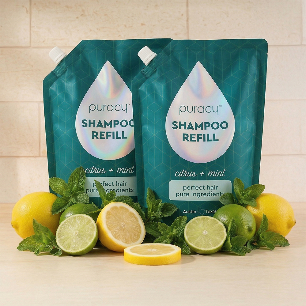 Two Shampoo (Sulfate/Paraben/Silicone-Free) refill pouches with lemons, limes, and mint leaves in front.
