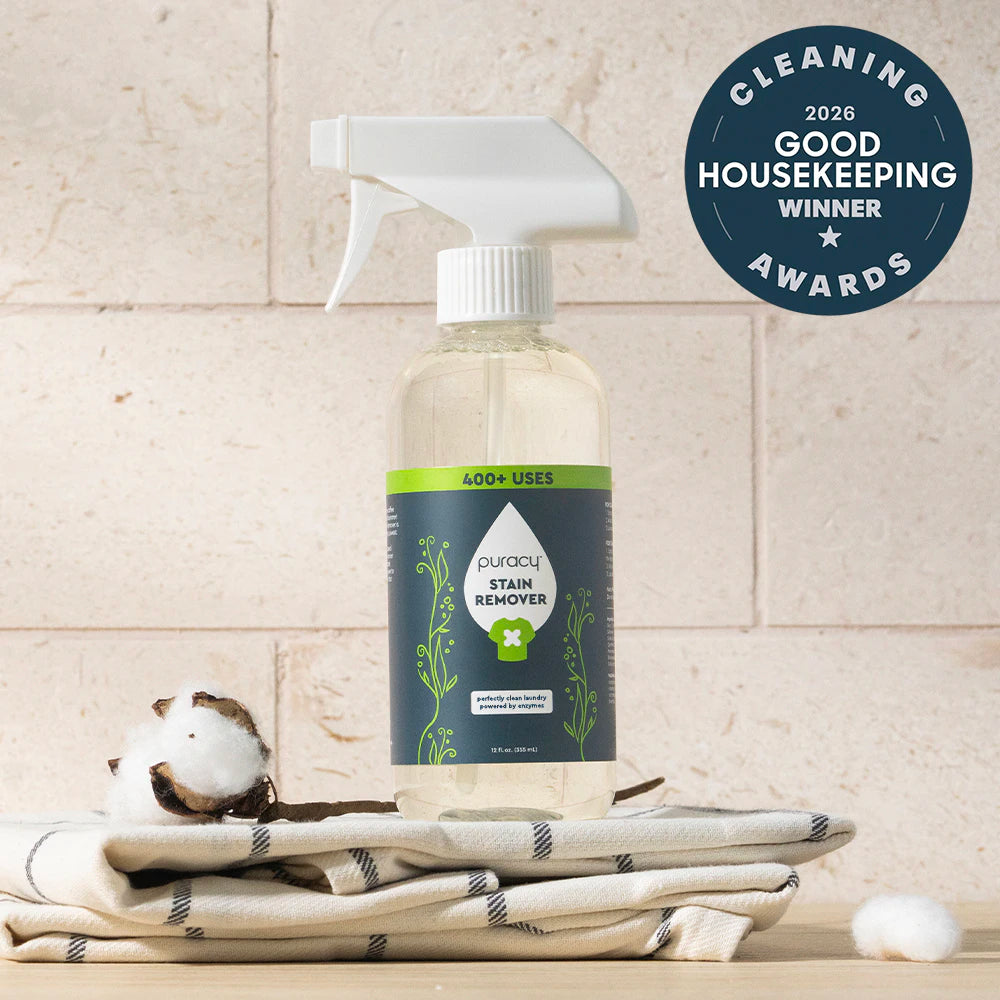 Laundry Stain Remover spray on cotton towels, featuring a 2026 Good Housekeeping award badge.
