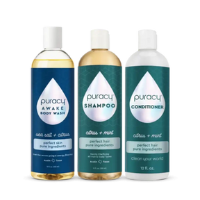 The Under the Shower Bundle from Puracy includes bottles of gentle shampoo, natural body wash, and conditioner, all featuring a citrus-themed design and placed side by side.