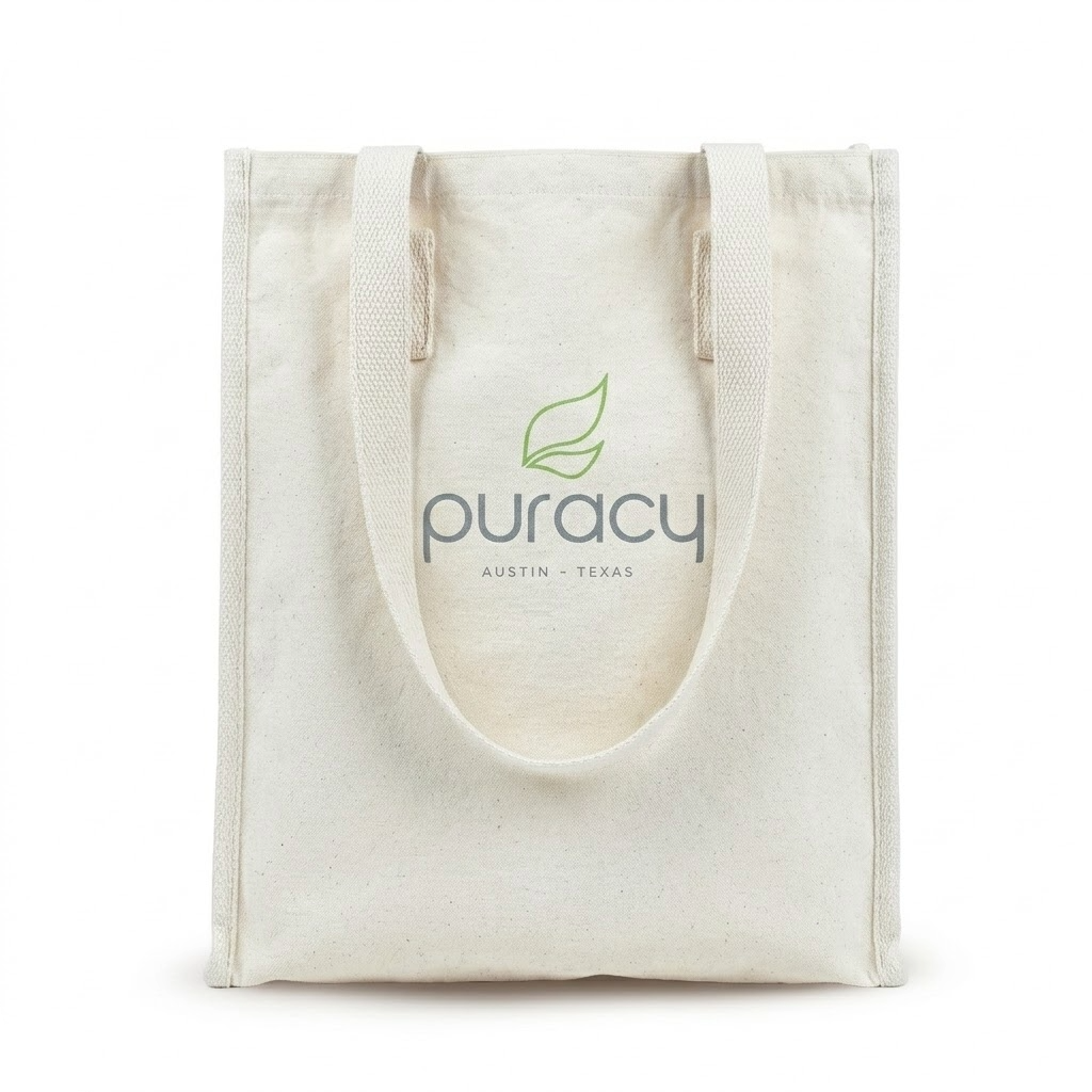 Cream tote bag featuring the Puracy Austin, Texas logo and a green leaf design on the front.