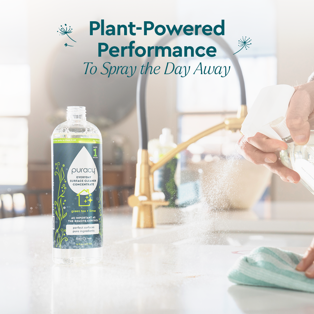 A hand sprays Refill (Natural Multi-Surface Cleaner Concentrate) on a kitchen counter by a gold faucet.#scent_green-tea-&-lime|size_concentrate